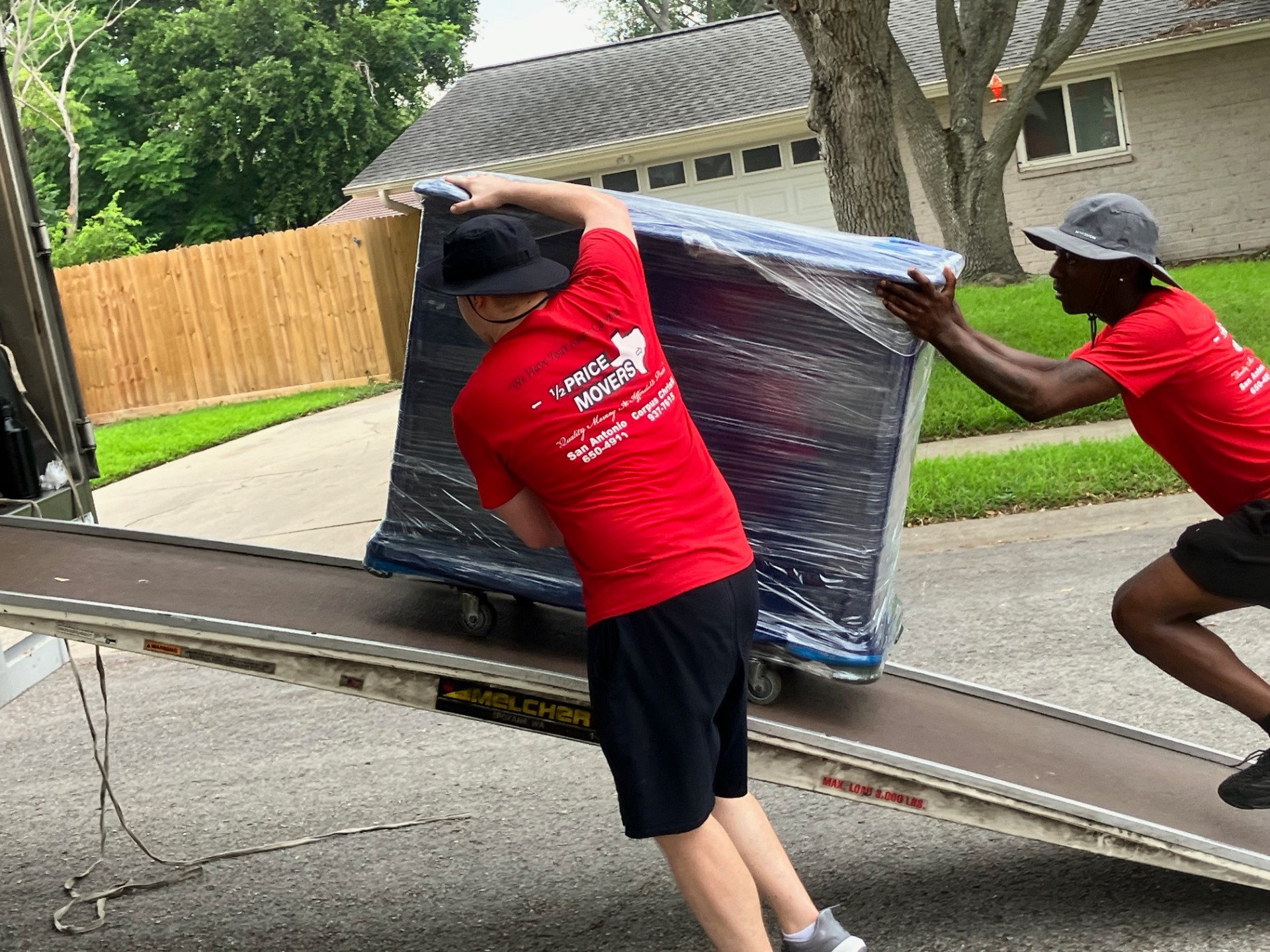 Half Price Movers crew carefully moving large equipment